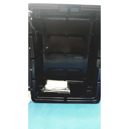 Black plastic defibrillator storage cabinet wall mount with molded compartments and a small wrapped item inside