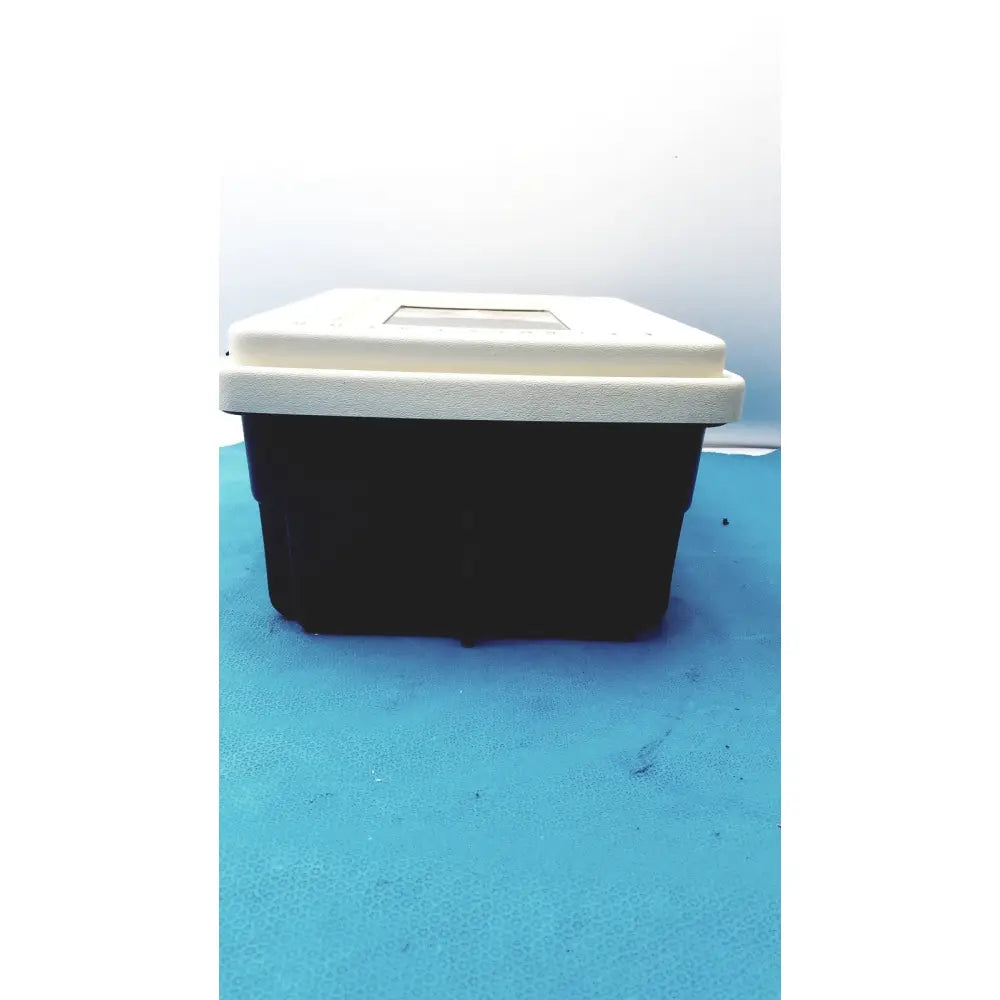 Black and white plastic defibrillator storage cabinet wall mount with rectangular transparent window on the lid