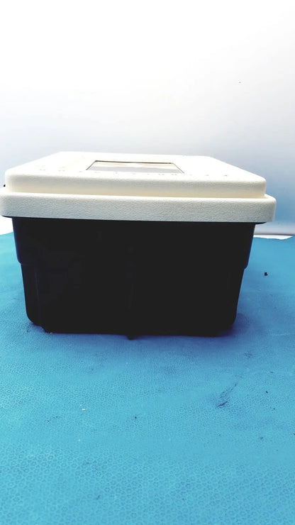 Black and white plastic defibrillator storage cabinet wall mount with rectangular transparent window on the lid