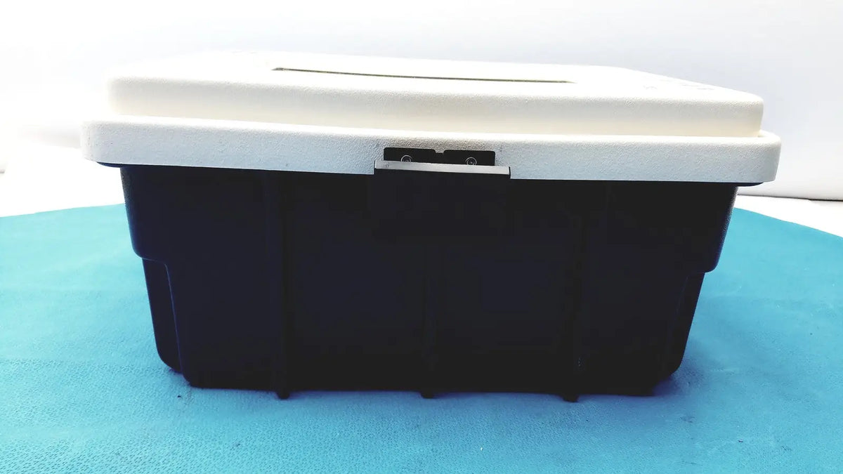 Black and white plastic defibrillator storage cabinet wall mount with silver latch for secure equipment storage