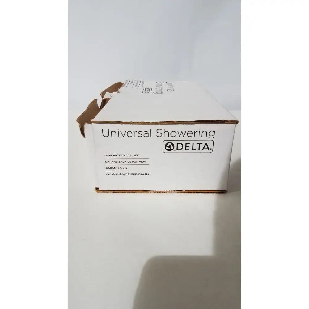 White cardboard box for delta 550pbbx h2okinetic raincan shower head in polished brass with multi-function features