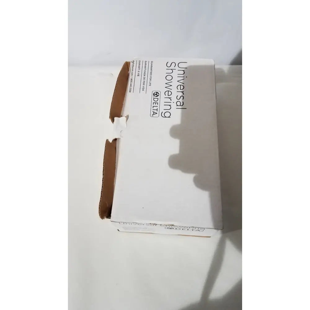 White cardboard box for delta 550pbbx h2okinetic raincan shower head in polished brass multi-function design
