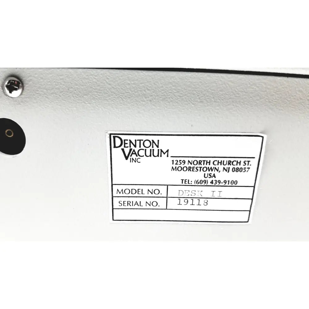 White label on white surface identifies denton vacuum desk II bench-top evaporator and sputtering system by denton vacuum