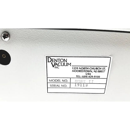 White label on white surface identifies denton vacuum desk II bench-top evaporator and sputtering system by denton vacuum