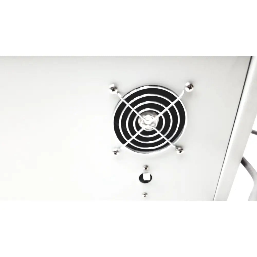 Silver circular fan grille with black concentric rings and four metallic balls on denton vacuum desk ii bench-top evaporator