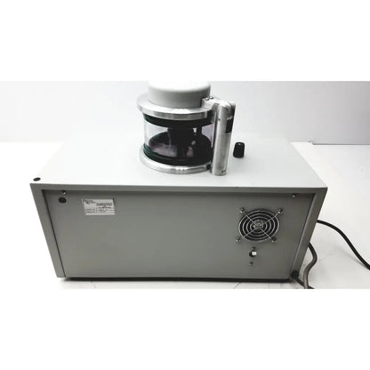 Gray metal laboratory centrifuge with transparent rotor chamber and silver handle in denton vacuum desk evaporator system