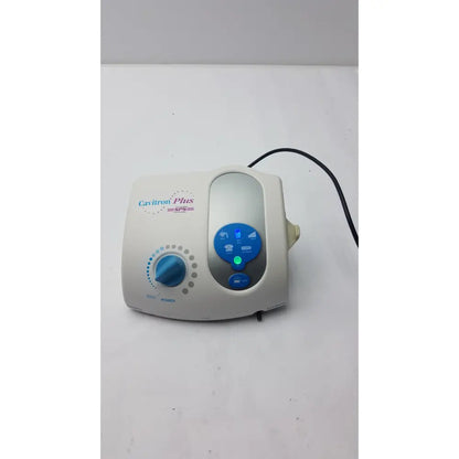 White and blue dentsply caviitron plus ultrasonic scaling unit with circular power dial and three function buttons