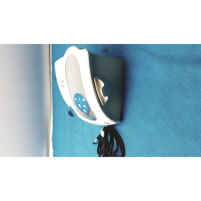 White and teal dentsply cavitron plus ultrasonic scaling unit with curved design and blue front control buttons