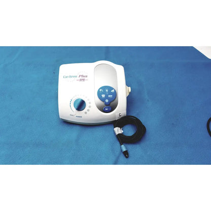 White dentsply cavitron plus ultrasonic scaling unit with blue control panel and black coiled hose for dental use