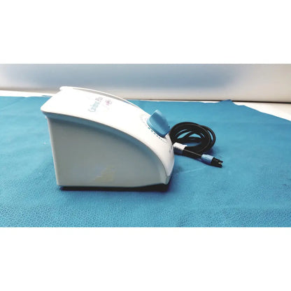 White and light blue dentsply cavitron plus ultrasonic scaling unit with curved design and prominent blue dial on top