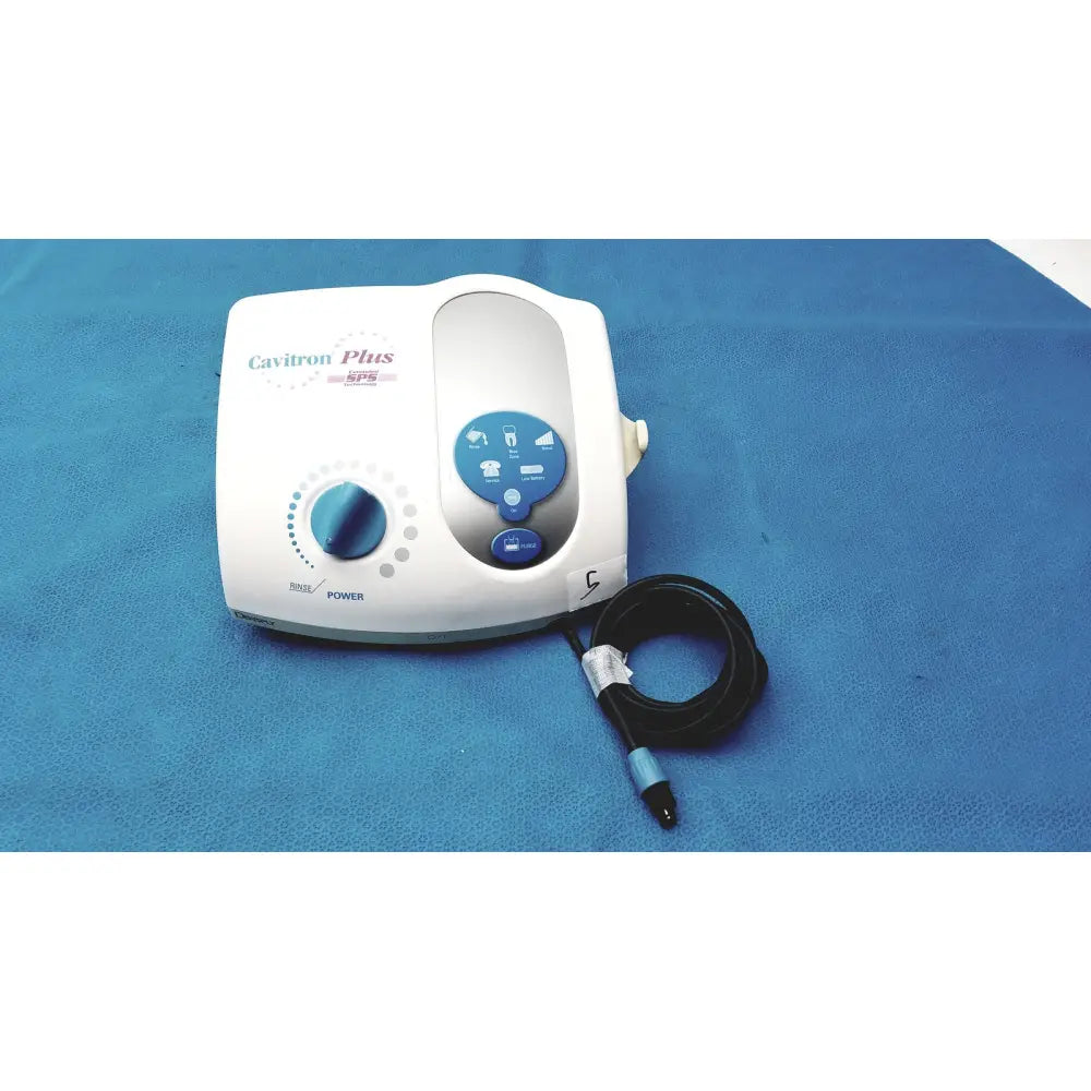 White and blue dentsply cavitron plus ultrasonic scaling unit with coiled black hose for dental use