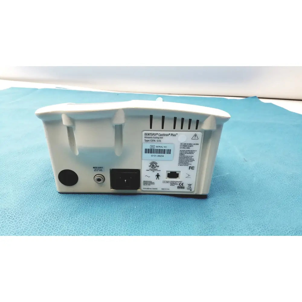 White plastic dentsply cavitron plus ultrasonic scaling unit back with ventilation slots and labeled ports model gen-131