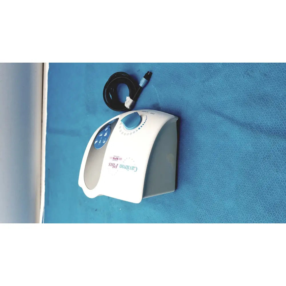 White and blue dentsply cavitron plus ultrasonic scaling unit with coiled black power cord for dental use