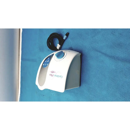 White and blue dentsply cavitron plus ultrasonic scaling unit with coiled black power cord for dental use