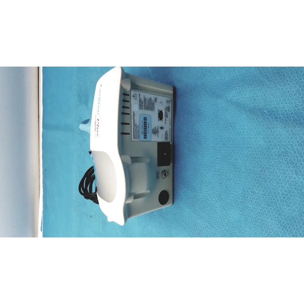 White and gray dentsply cavitron plus ultrasonic scaling unit with curved top labeled nellcor for dental use