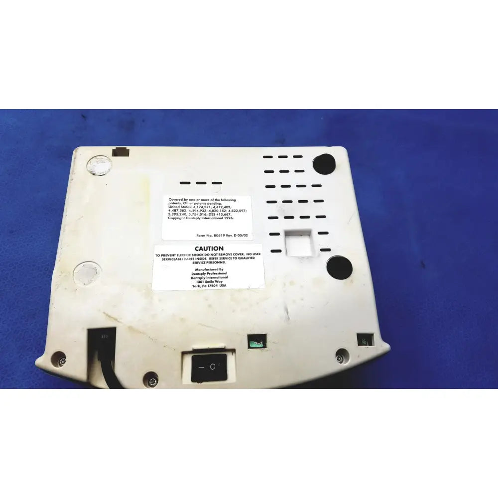 White plastic back side of dentsply cavitron plus ultrasonic scaling unit with black vents and patent labels visible