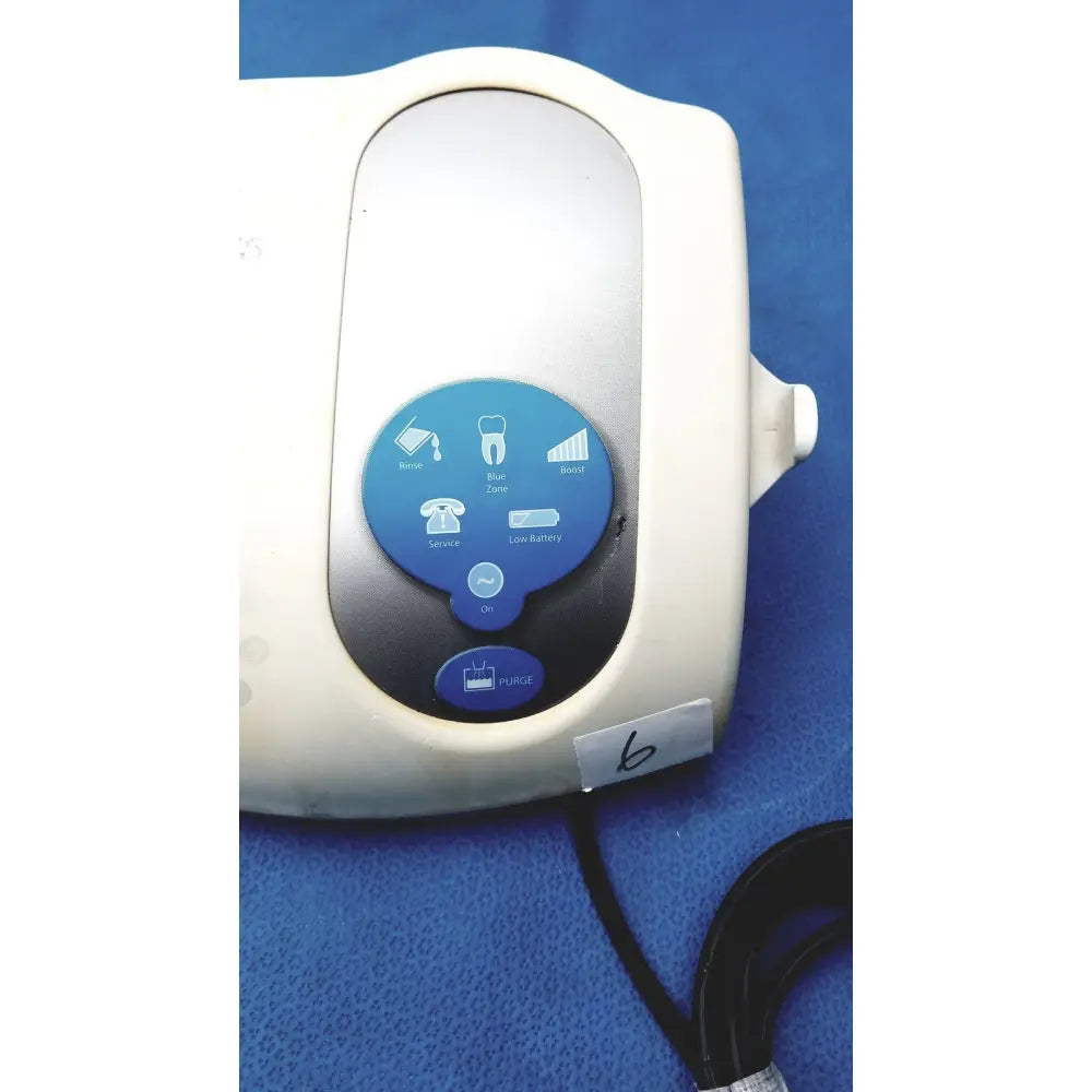 White plastic dentsply cavitron plus ultrasonic scaling unit with blue circular control panel and rinse icons type gen-131