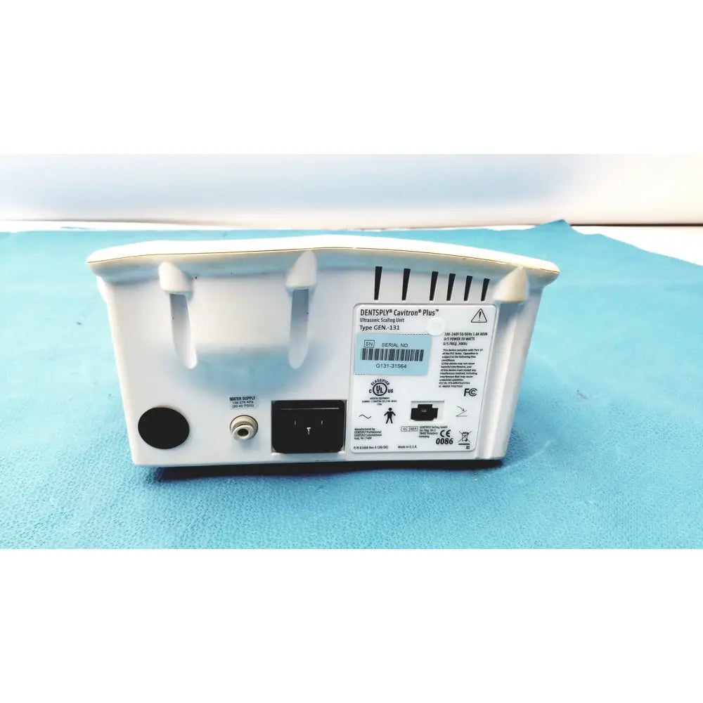 White plastic dentsply cavitron plus ultrasonic scaling unit gen-131 back panel with ventilation slots and power ports