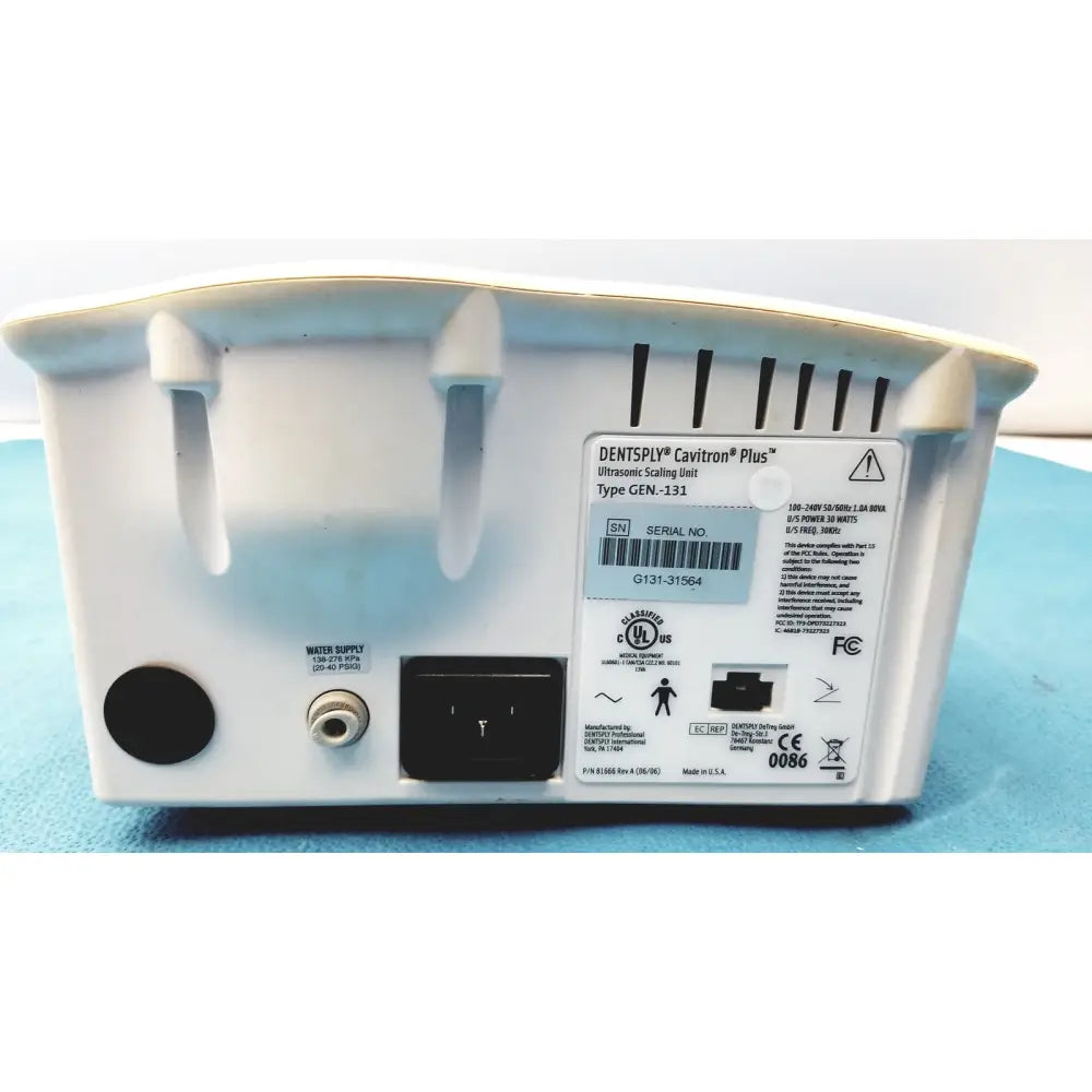 White plastic dentsply cavitron plus ultrasonic scaling unit with matte finish and molded handles for easy transport