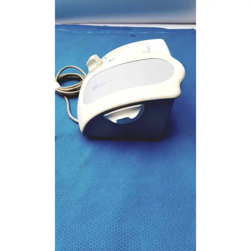 White and blue plastic dentsply cavitron plus ultrasonic scaling unit type gen-136 with curved design and control buttons