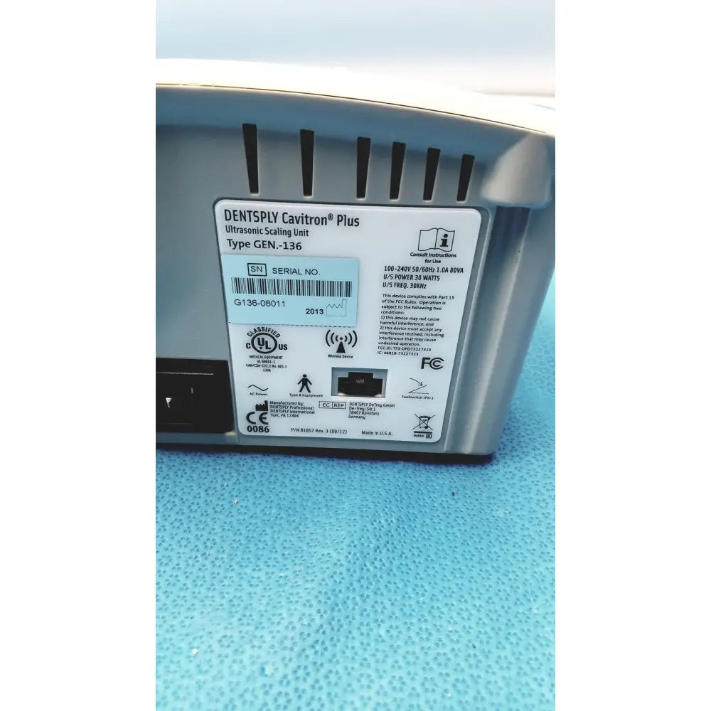 Silver-colored dentsply cavitron plus ultrasonic scaling unit with matte finish and black ventilation slits along top edge