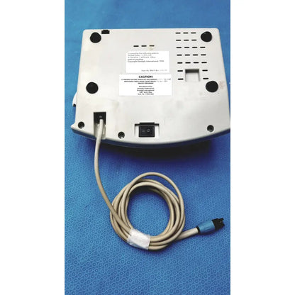 White plastic dentsply cavitron plus ultrasonic scaling unit with beige coiled cable and blue connector for dental use