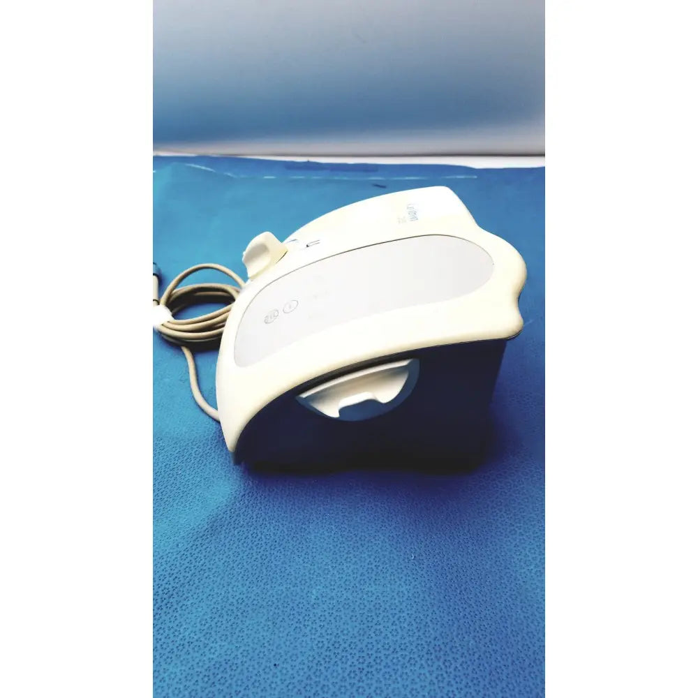 White and dark blue plastic dentsply cavitron plus ultrasonic scaling unit with coiled beige power cord