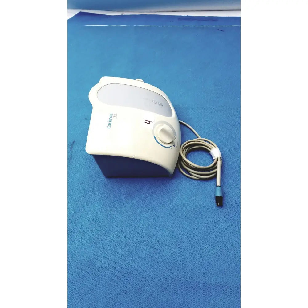 White and blue dentsply cavitron plus ultrasonic scaling unit with gray coiled cord for advanced dental care