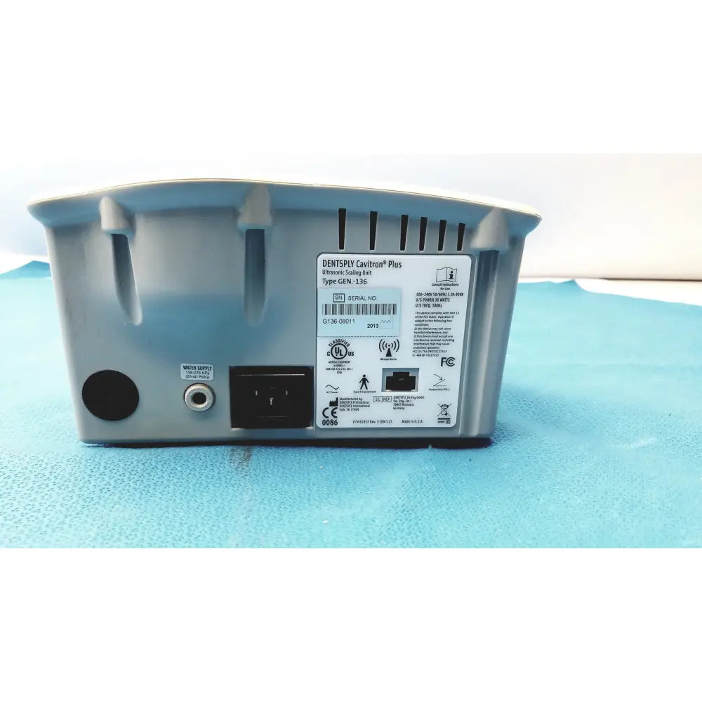 Gray plastic dentsply cavitron plus ultrasonic scaling unit type gen-136 with label showing model and certification markings