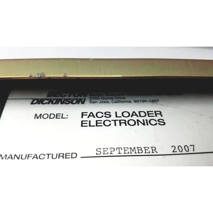 White label with black text identifying dickinson facs loader electronics interface module manufactured september 2007