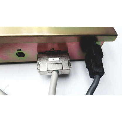 Silver industrial d-sub connector labeled p1 with white cable plugged in on back of dickinson facs loader electronics module