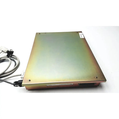 Rectangular metallic dickinson facs loader interface module with brushed gold finish and visible edge screws