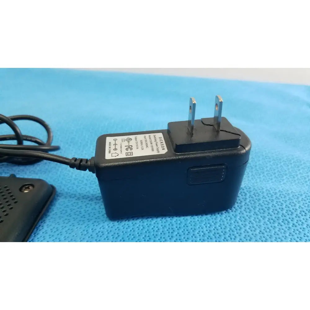 Black plastic power adapter with two-prong plug and coiled cable for dickson data logger model ft630