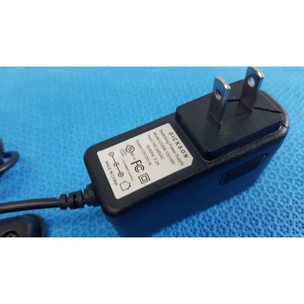 Black plastic dickson data logger ac adapter with two-prong plug and attached power cord for model ft630 recorder