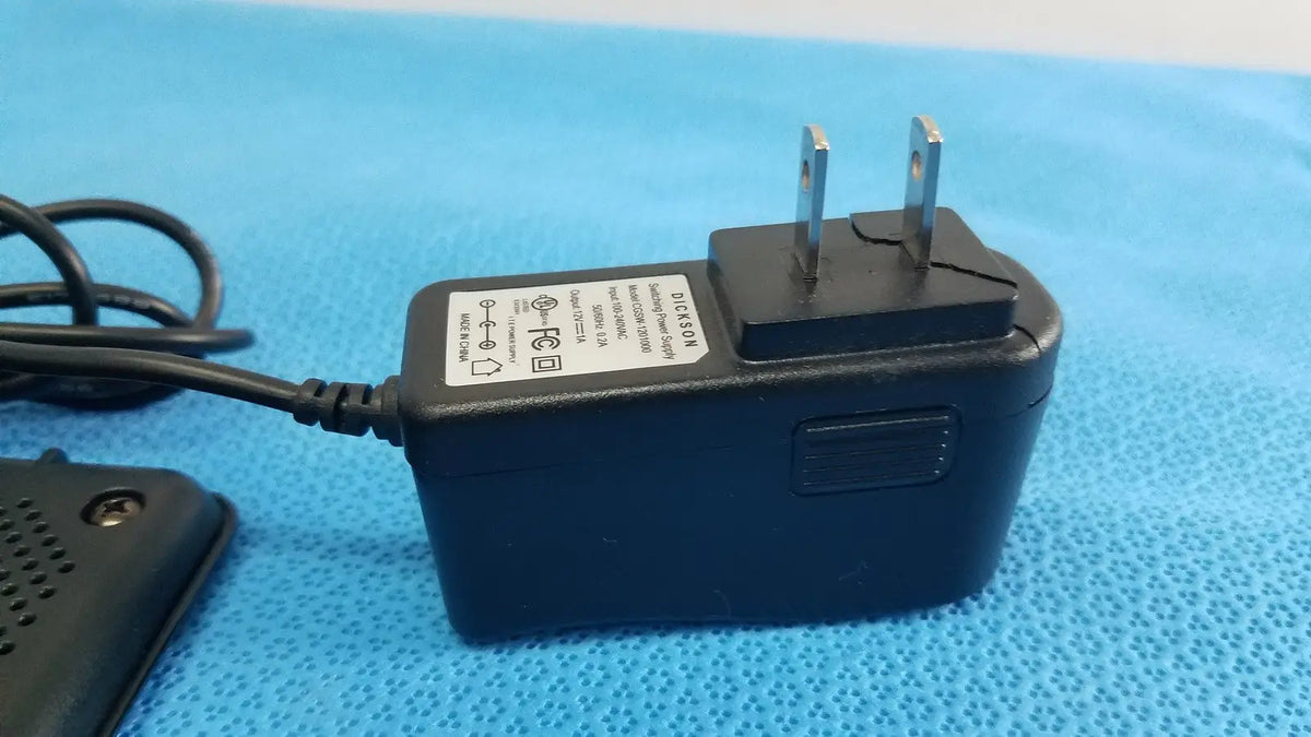 Black plastic power adapter with two-prong plug and coiled cable for dickson data logger model ft630