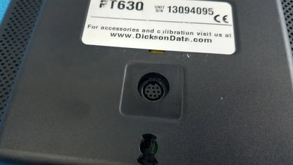 Black plastic dickson data logger model ft630 with white label and circular connector port on the back side