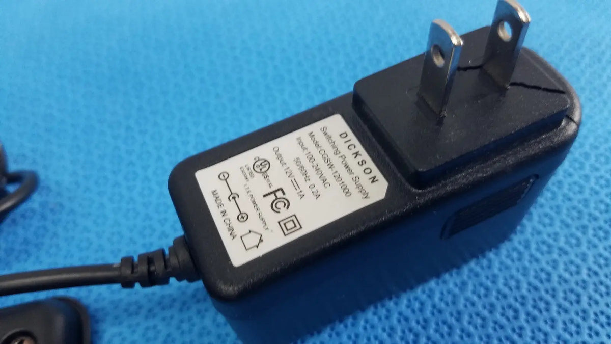 Black plastic dickson data logger ac adapter with two-prong plug and attached power cord for model ft630 recorder