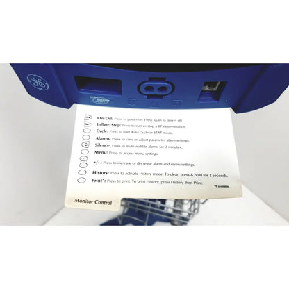 Blue GE brand control panel with printed instructions on the dinamap dcp400n-en patient monitor display