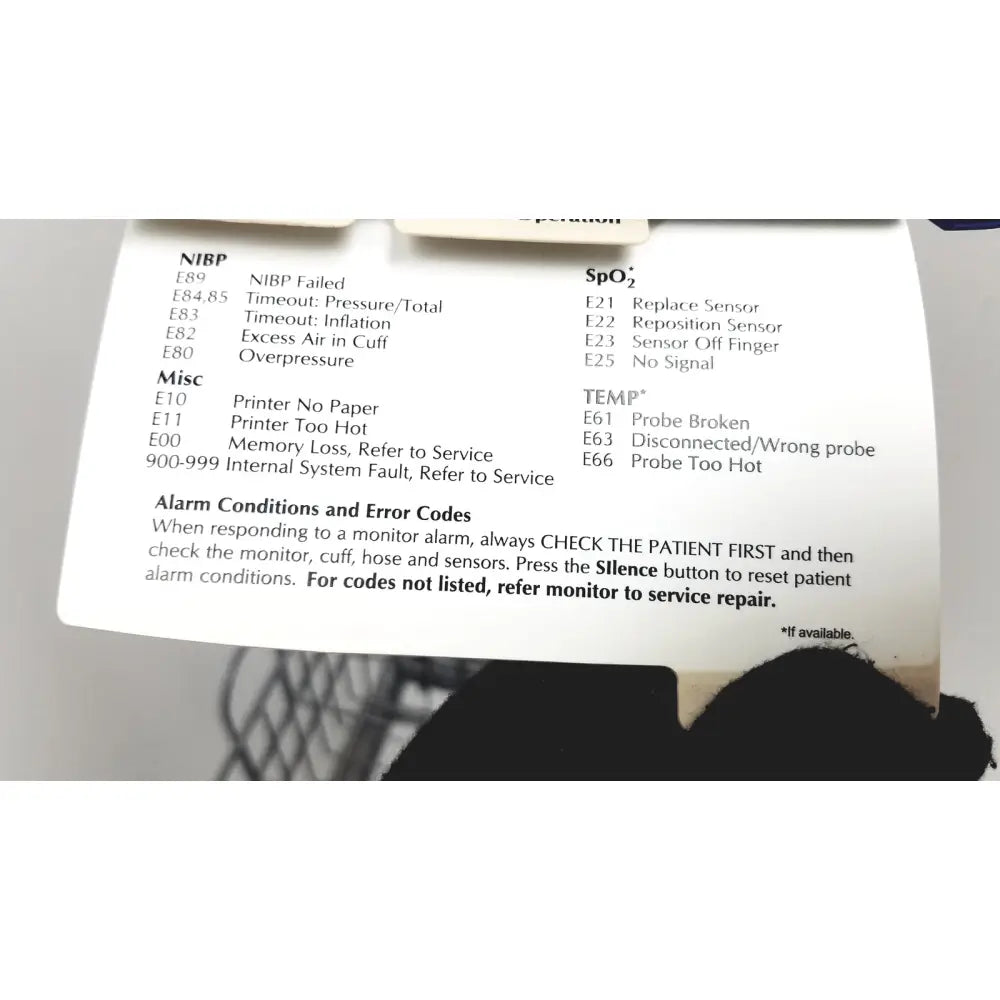 White paper label with black printed medical monitor error codes on the dinamap dcp400n-en patient monitor product