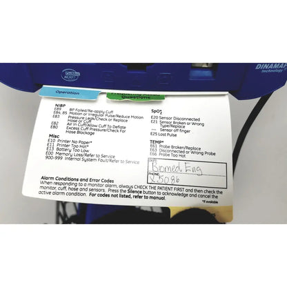 Blue dinamap v100 vital signs monitor with rolling stand and attached printed error code reference sheet