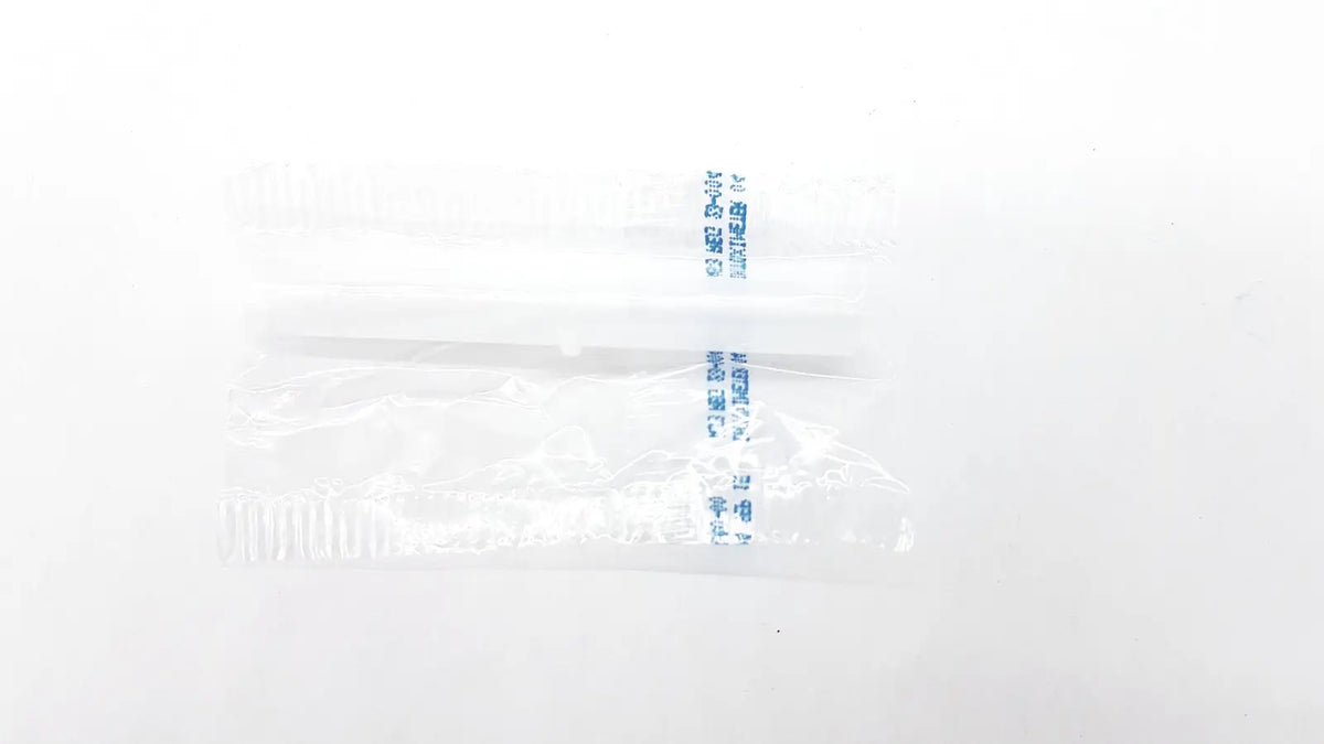 Clear plastic bag containing two white disposable dental things with blue printed text for reuse medical use
