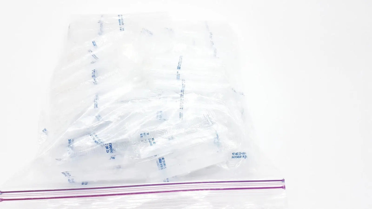 Clear plastic zip-top bag containing multiple individually wrapped white disposable dental things for single use