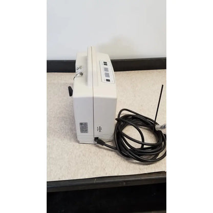 White plastic djo aircast venaflow 30a vascular system with a coiled black power cord and antenna for compression therapy