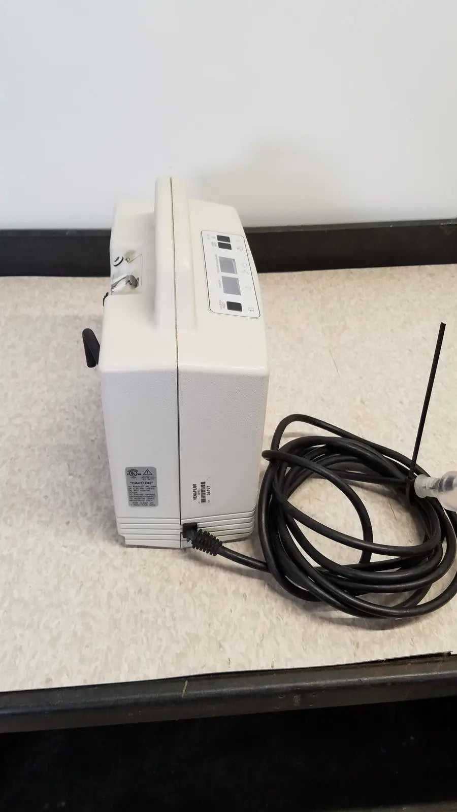 White plastic djo aircast venaflow 30a vascular system with a coiled black power cord and antenna for compression therapy