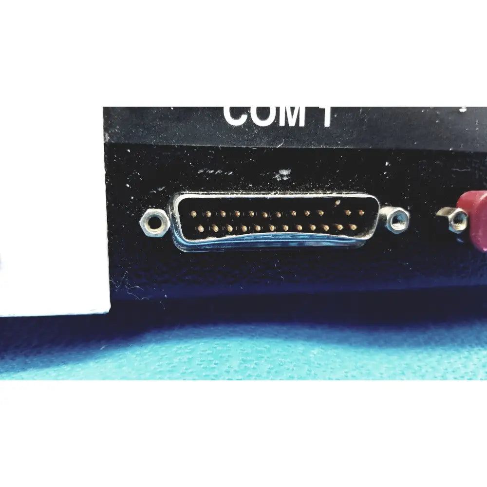 D-sub 15-pin female connector with metallic contacts and black plastic housing labeled com 1 on dni nevada medTester 5000 electrical safety analyzer