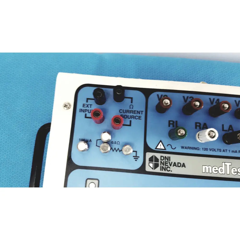Blue and white DNI Nevada medTester 5000 electrical safety analyzer panel with red black green and silver connectors