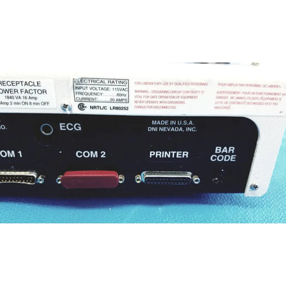 Black panel with red and silver connectors labeled ecg com 1 com 2 printer and bar code on dni nevada medtester 5000 electrical safety analyzer back side