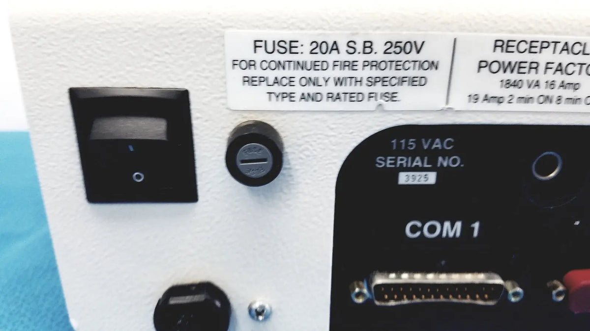 White industrial control panel with black switch and labeled ports including com 1 on dni nevada medTester 5000 electrical safety analyzer