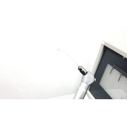 Silver dental handpiece with black-tipped nozzle and metallic body on dntl works p-2000 dental delivery unit with midwest rhino