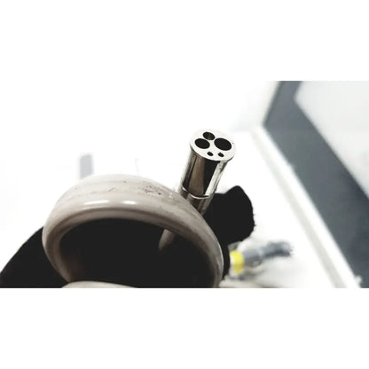 Silver metallic trumpet valve with three circular holes on polished body of dntl works p-2000 dental delivery unit